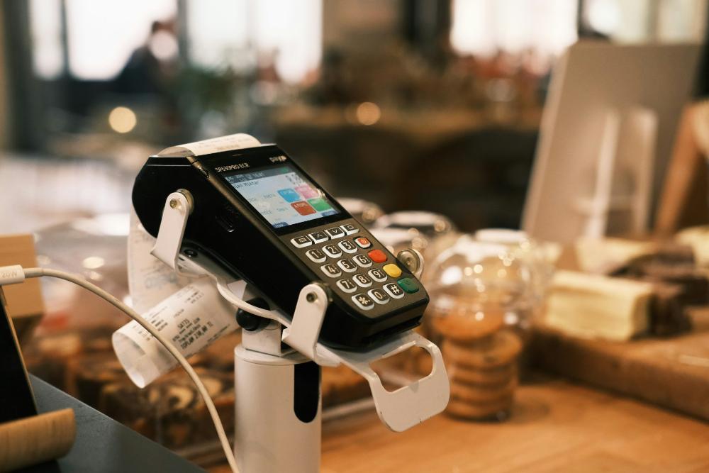 Payment terminal in cafe setting.